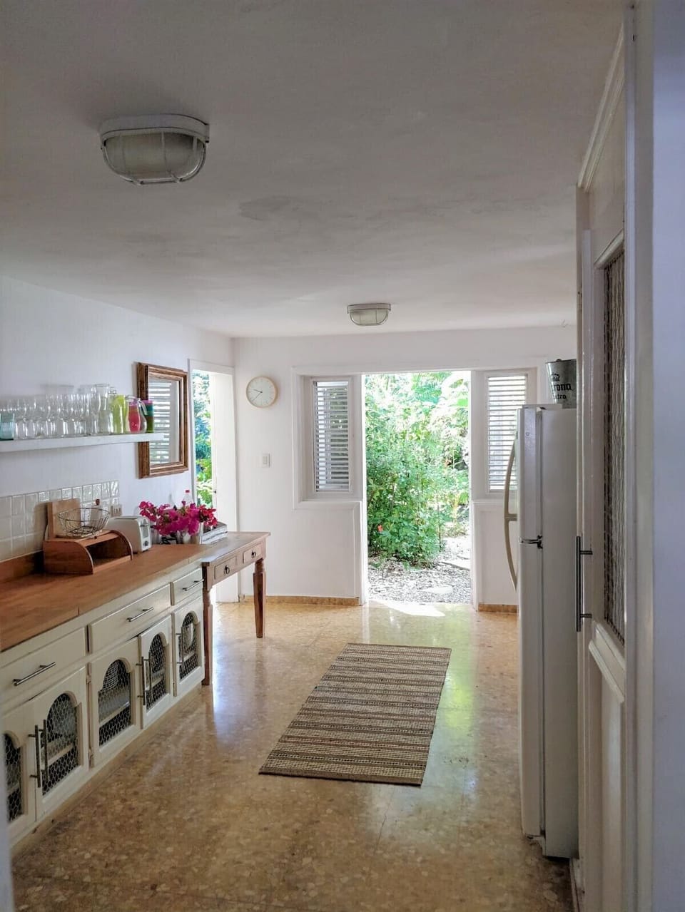Fully equipped kitchen with double doors, leading out to pool and garden