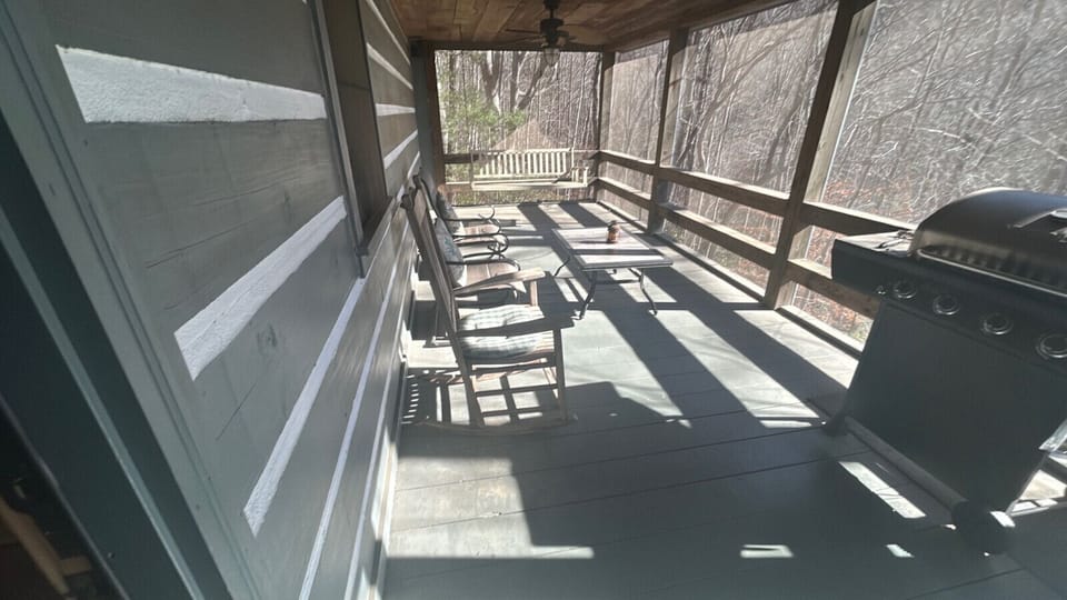 screened porch with grill and picnic table