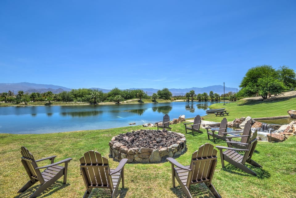 Large circular fire pit next to river and lake.