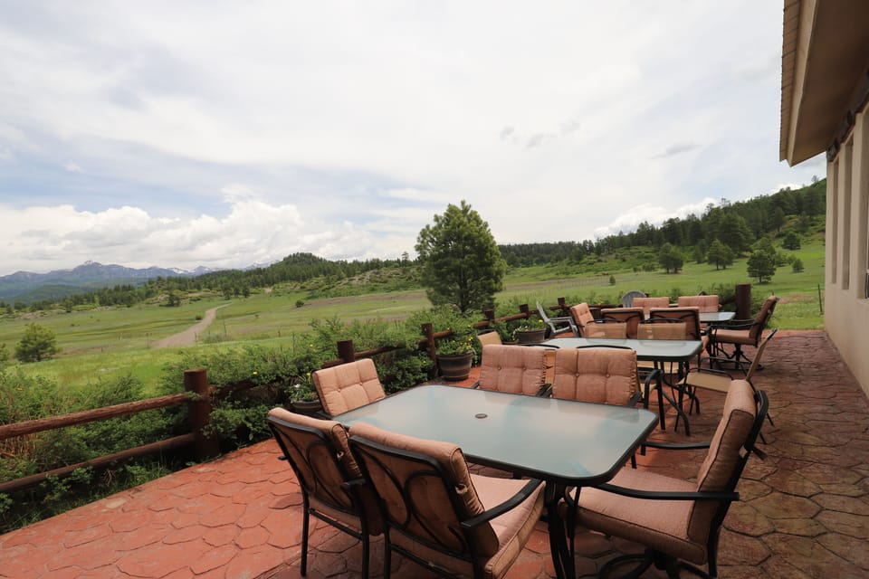 Large patio with outdoor with 2 large patio tables. Seats 12.