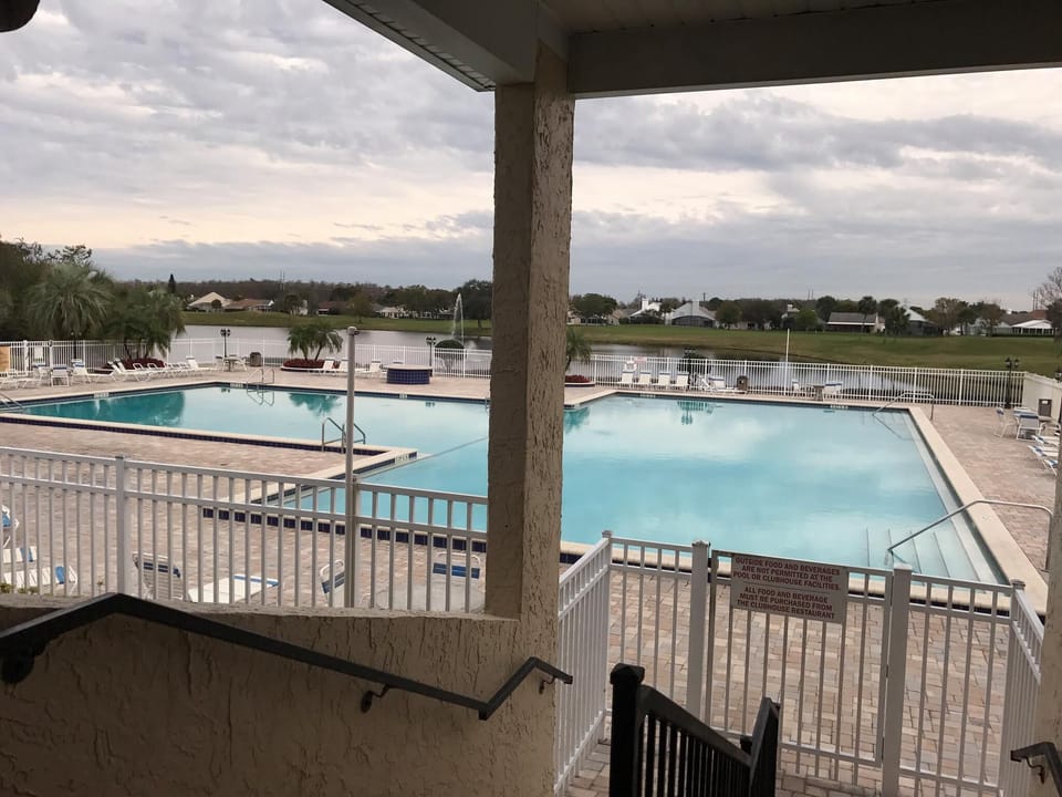 View from Sports bar/19th Hole Restaurant of Olympic size pool,lake,fountain 