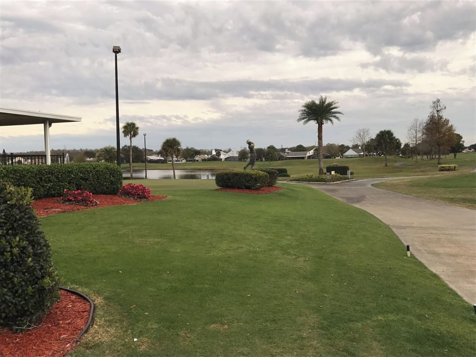 Path leading to putting green/golf course, restaurant and gym on left