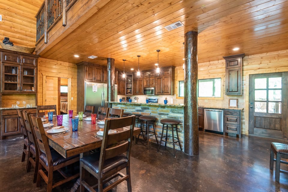 The fully stocked chef’s kitchen features a gas double oven and oversized refrigerator.