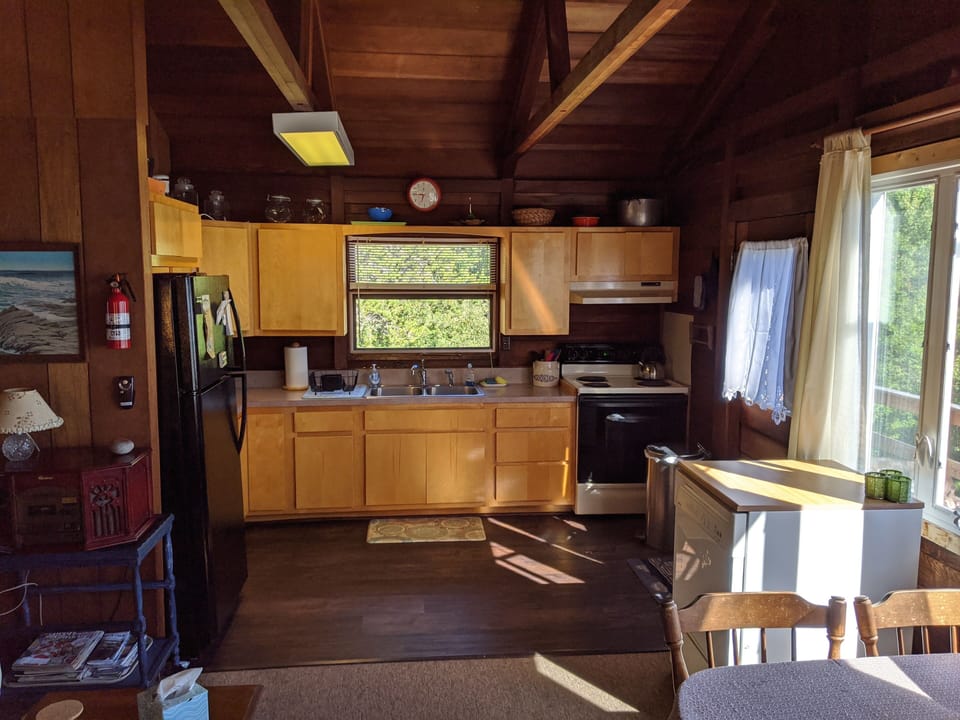 Kitchen with new refrigerator (ice maker),  floor, and microwave.