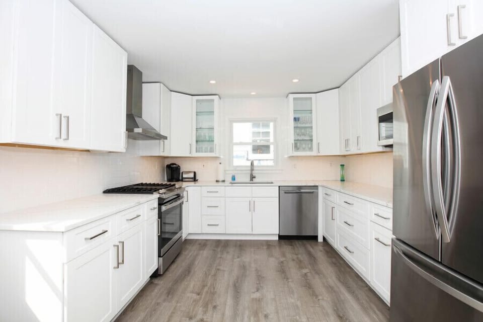Kitchen with Stainless Gas Appliances, Quartz Counters, Large Fridge