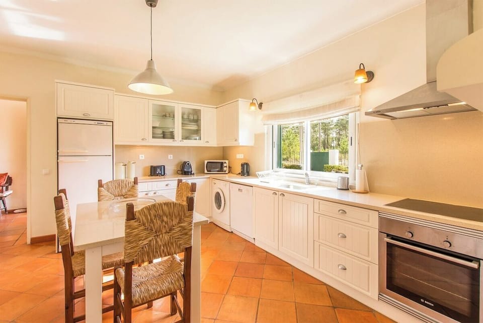 Spacious kitchen with cream cabinetry and orange terracotta floor — Villa Goreti, holiday villa in Belverde