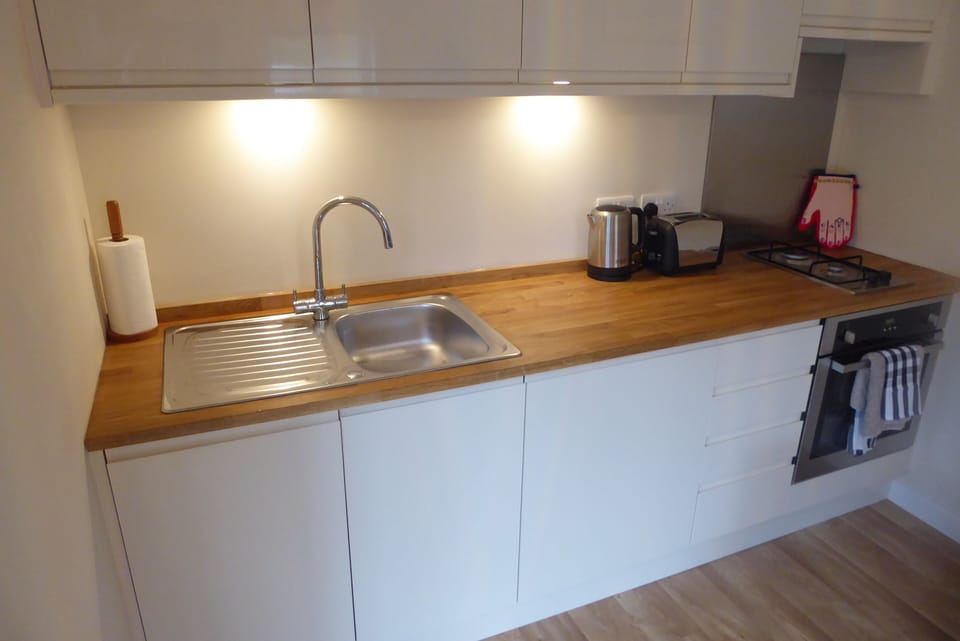 Kitchen with integrated fridge and dishwasher
