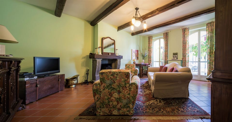 Living room with bright windows, TV 55' Sat a pretty fireplace, comfortable sofa