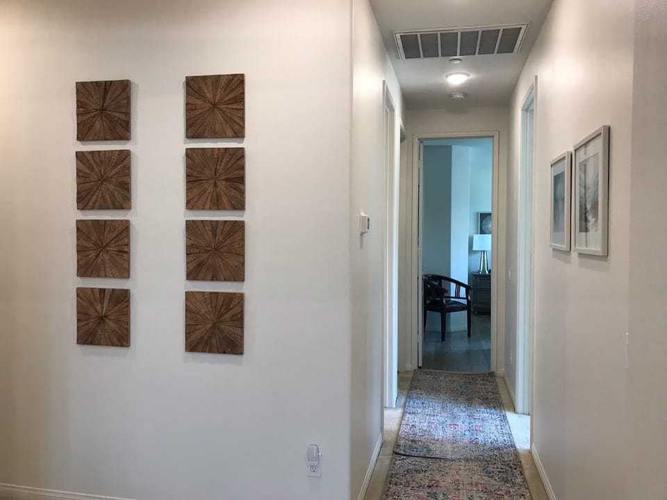 Entry area adjacent hallway to additional bedrooms. 