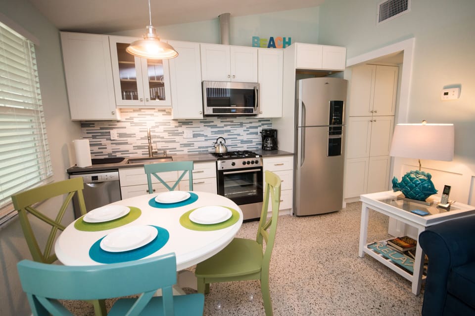Kitchen with full-size refrigerator and dishwasher.