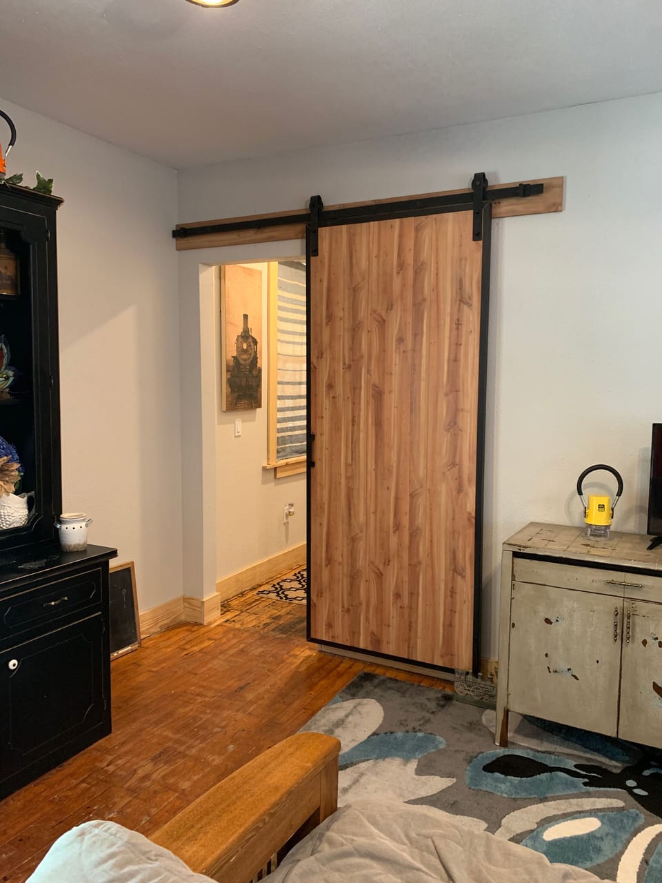 Sliding barn door to close off hallway that leads to bedroom and full bathroom.