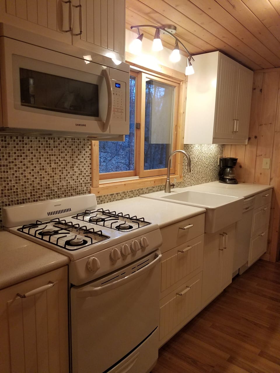 Efficient kitchen with quartz counters. Everything needed for meal prep & serve