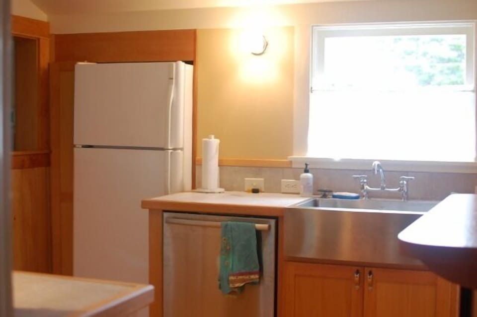 Kitchen features new salvage fir cupboards built on-site and marmoluem floor.