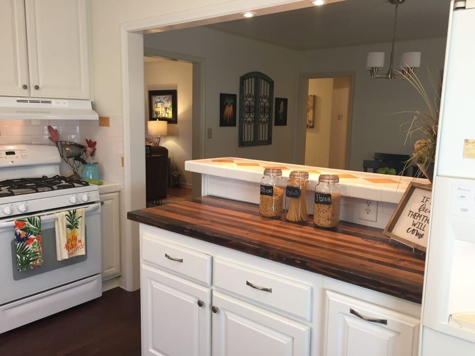 Kitchen, butcher block surface and bar area with seating
