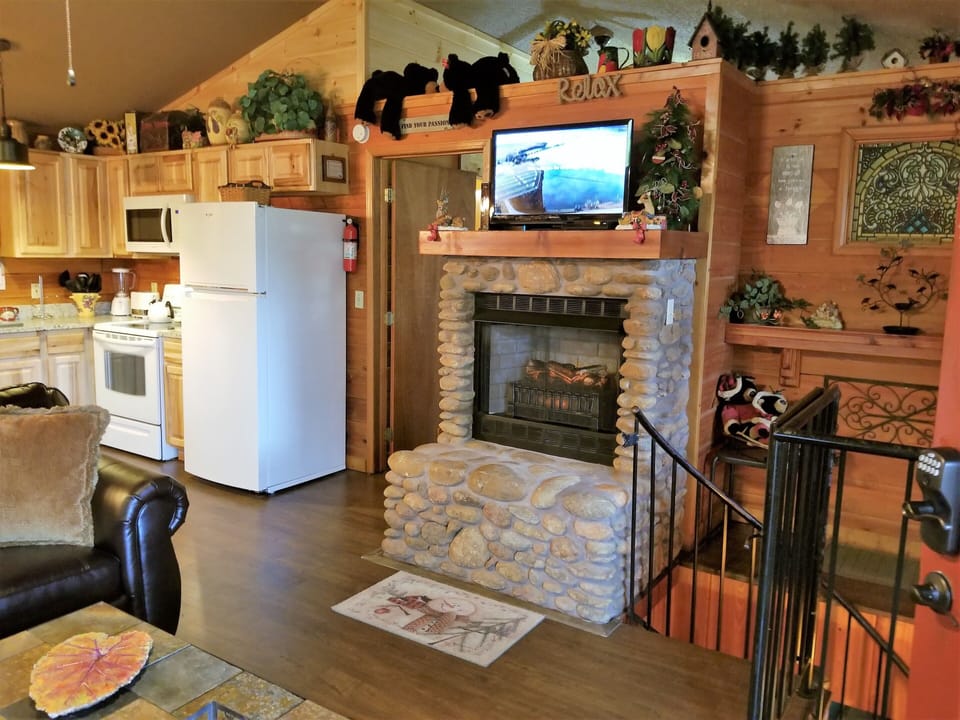 Spiral stairs lead to 2 lower-level bedrooms, a game room-hot tub-firepit-river