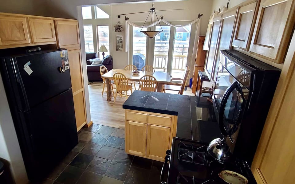 Fully furnished kitchen. Dining table seats 8, plus 2 stools at the counter. 