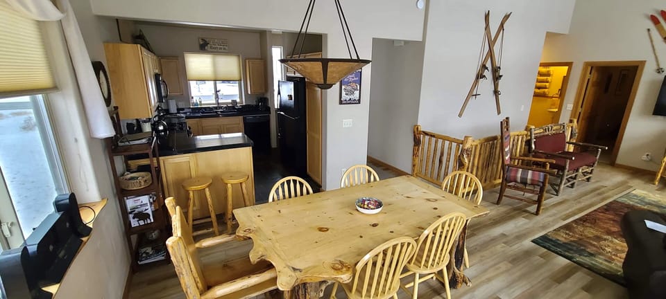Main level dining area, kitchen & living room from glass doors to the deck.