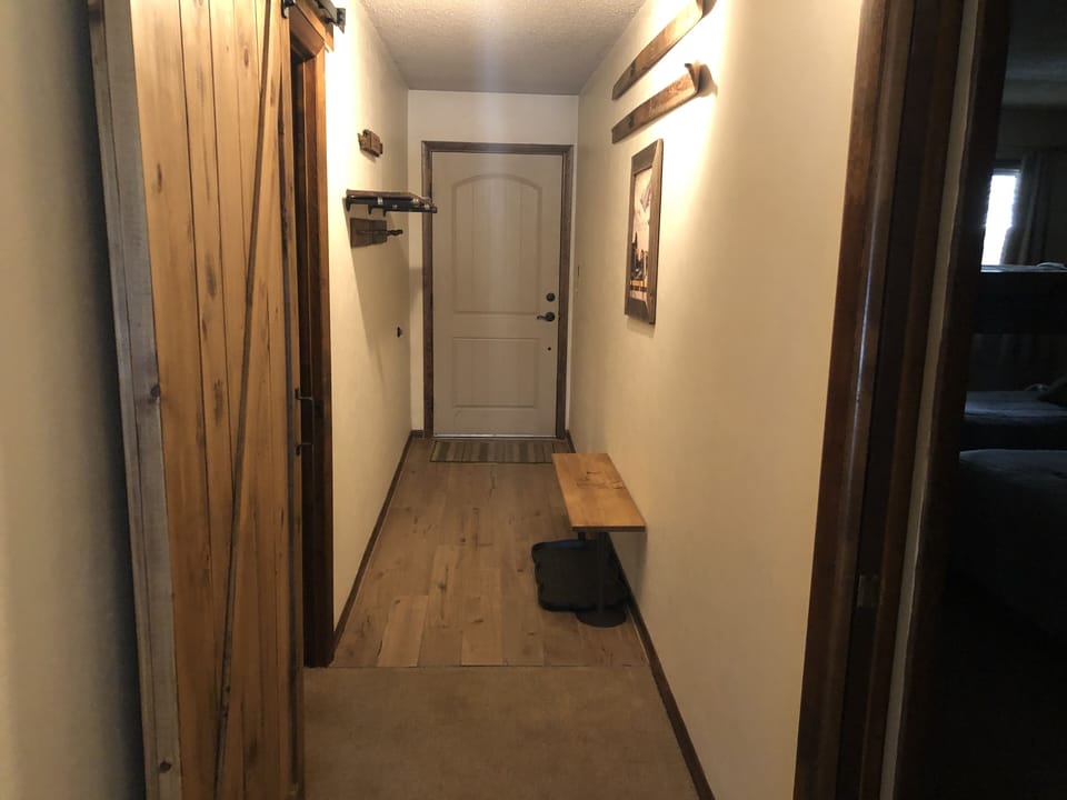 Hallway from entry door with bedroom entry left and right.