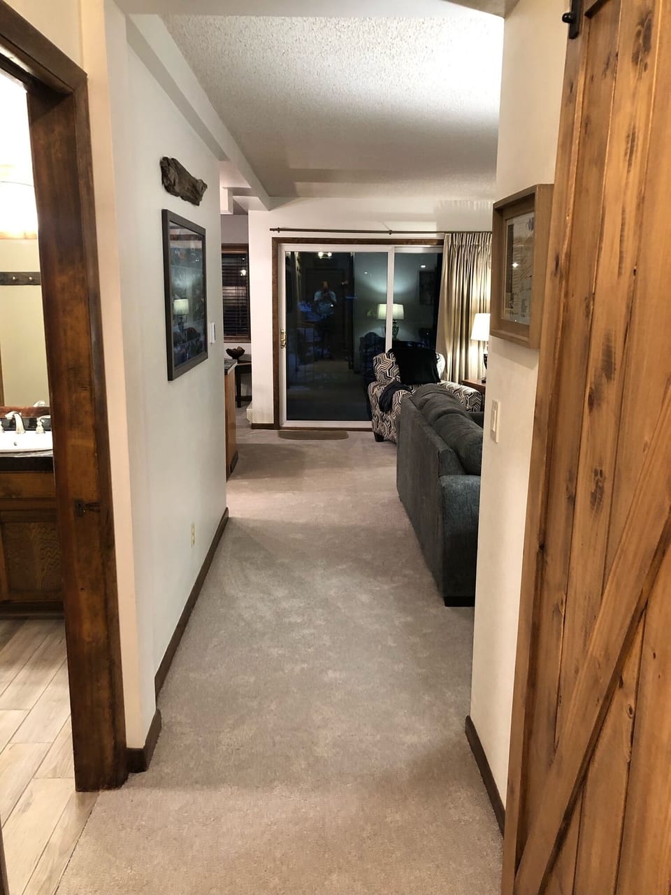 Hallway from entry, past bedroom suites to main living area.