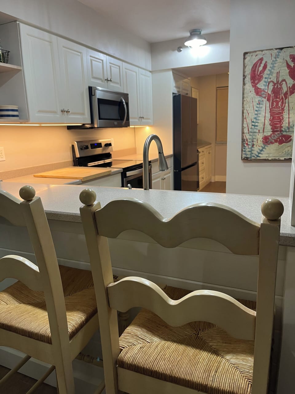 Fully stocked kitchen with counter seating and view of the ocean from the sink!