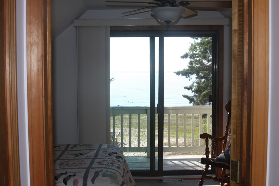 view from bedroom upstairs (full size bed and couch with full size bed)

