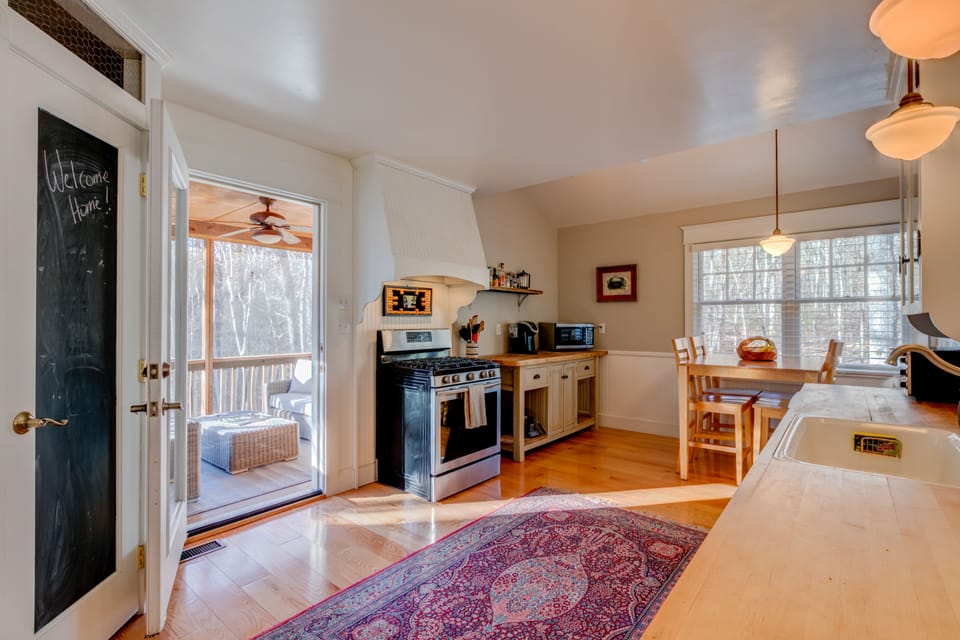 Kitchen looking out to the screened in porch