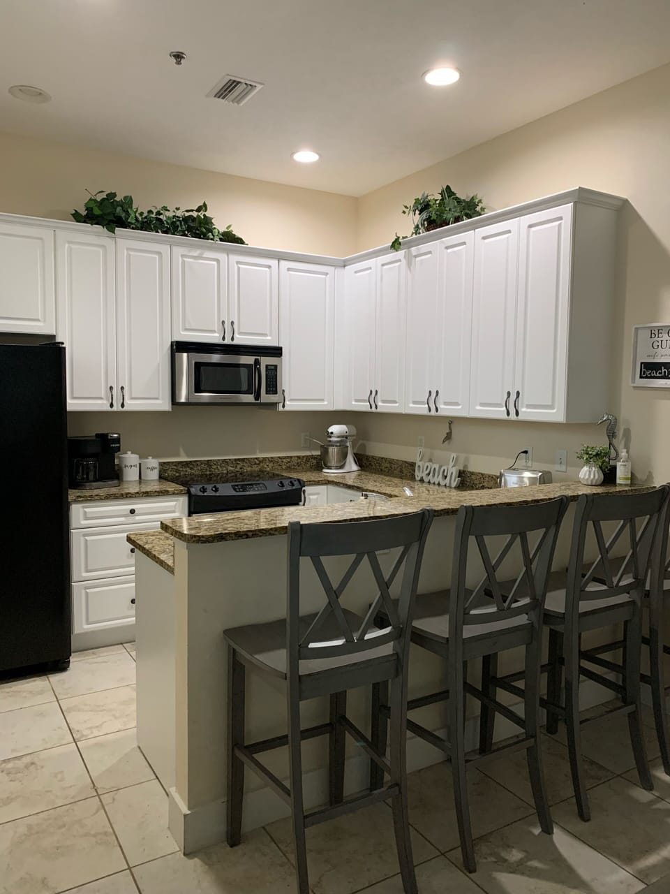 Fully Stocked Kitchen with Stone Countertops 