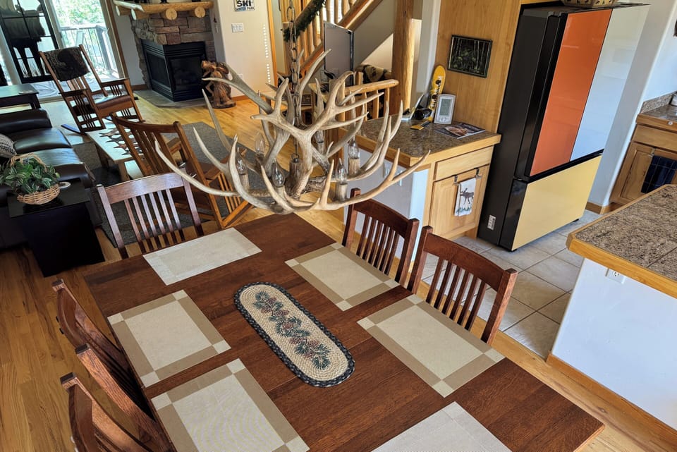 Dining table with seating for up to 10 between living room and kitchen.