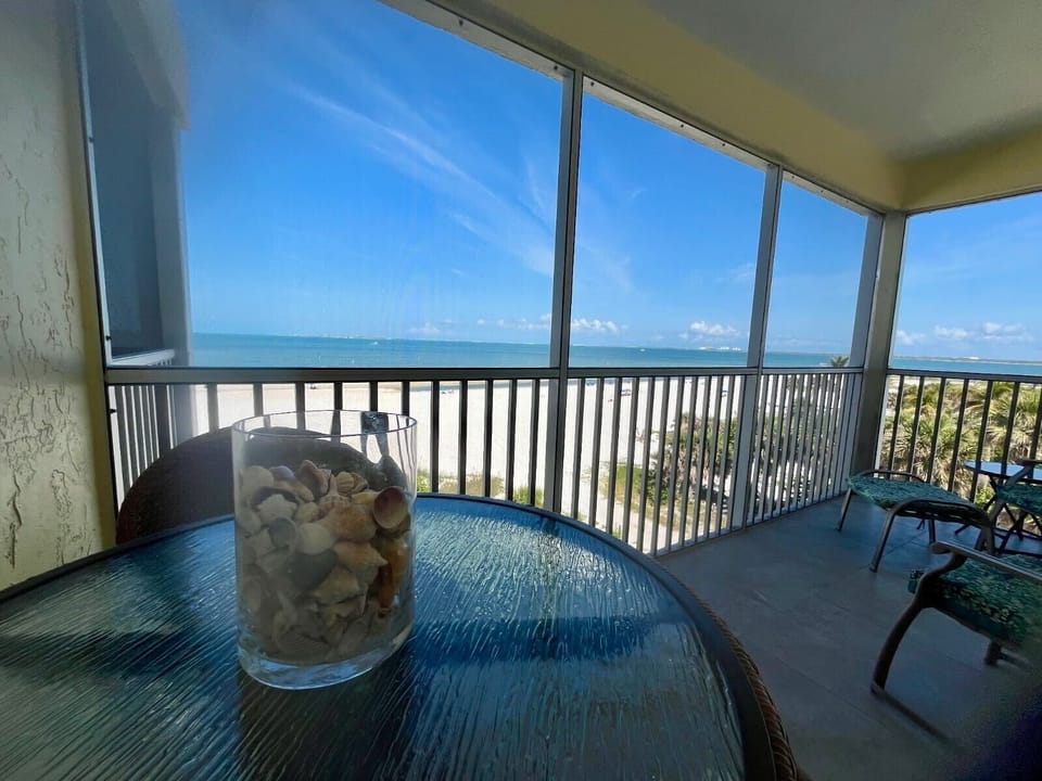 Bistro table for two overlooking the sandy white beach and water