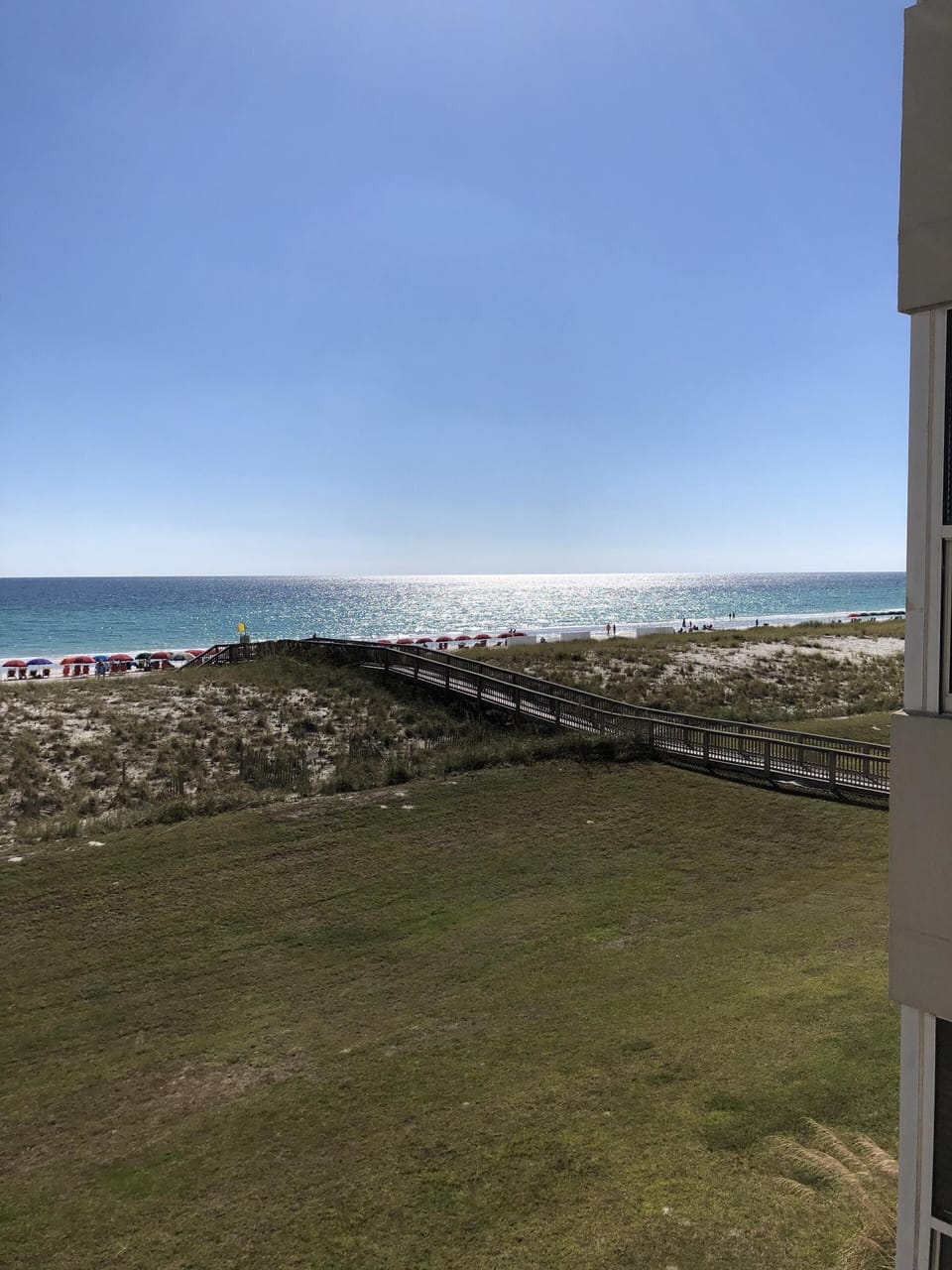 The walkway leads you from the pool area right to the white sandy beach.