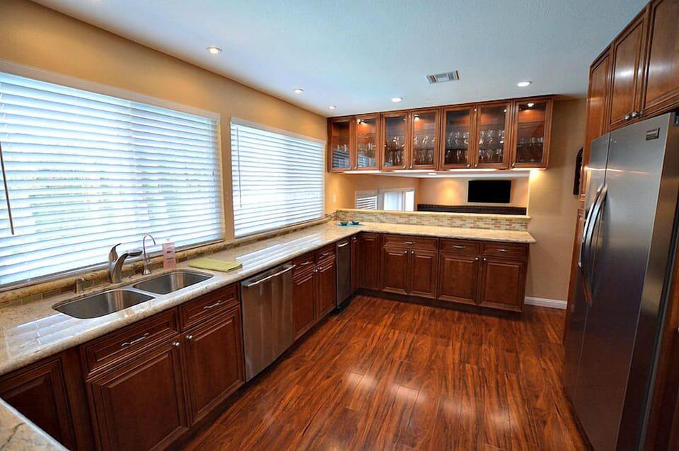 Gourmet kitchen complete with cooking utensils, appliances, pots, pans, stemware