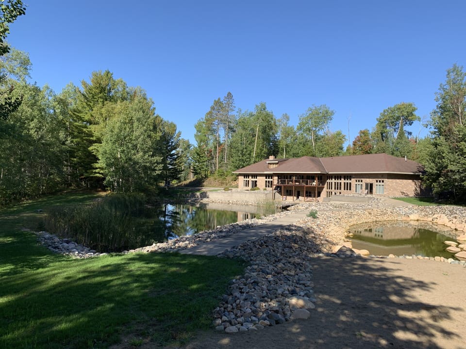 The yard of the lake home features two beautiful  man maid fish feeding ponds 