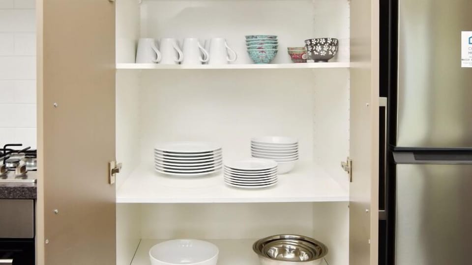 Well stocked with crockery, glasses and bowls.