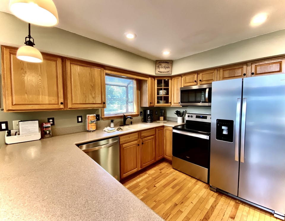 Stainless Steel Appliances (Newly Upgraded in 2022) and Solid Surface Counters in the Open Airy Kitchen