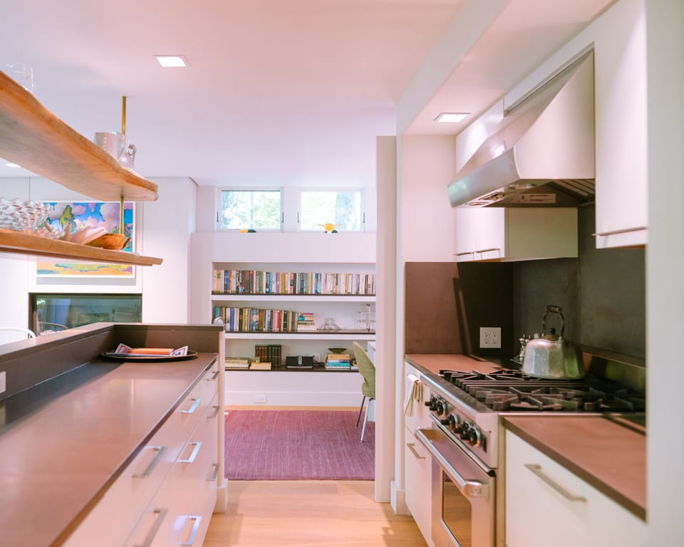 Galley kitchen opens to sitting and dining areas.