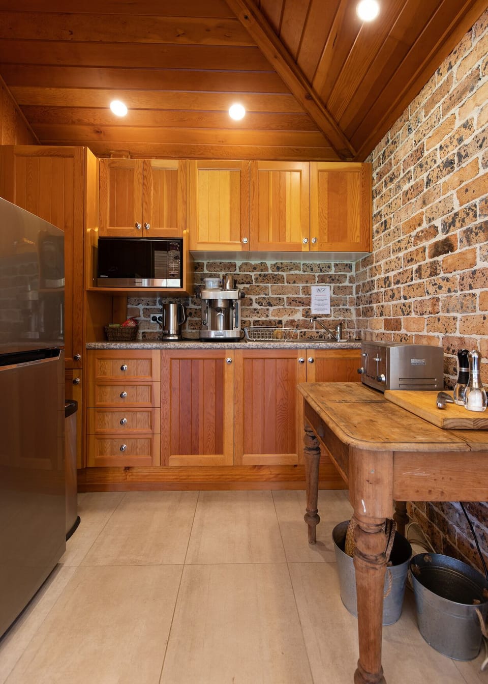 Kitchenette with microwave, mid size fridge, toaster and induction cook top.