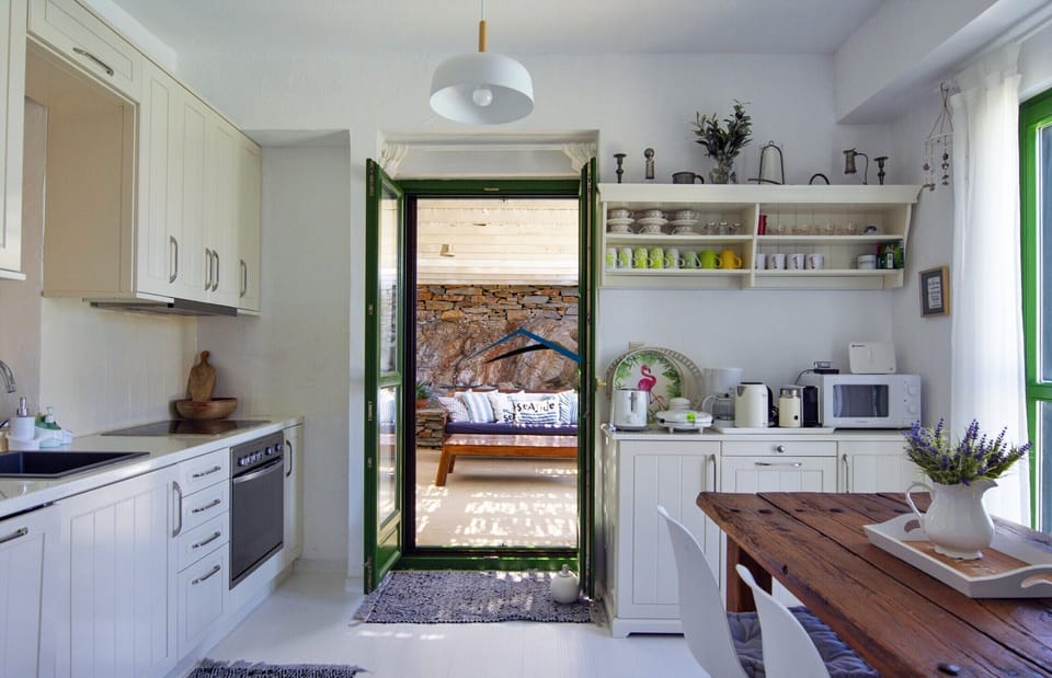 The indoor dining area & kitchen with direct access to the outdoor dining area