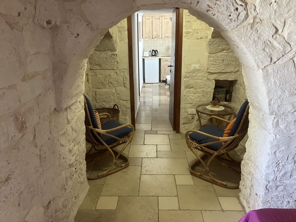 Trullo, from villa through to kitchen. If sleeping 4, a bed replaces chairs. 