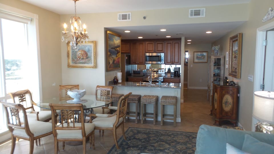 View of kitchen, dining room and hallway from the living room (high-end decor). 