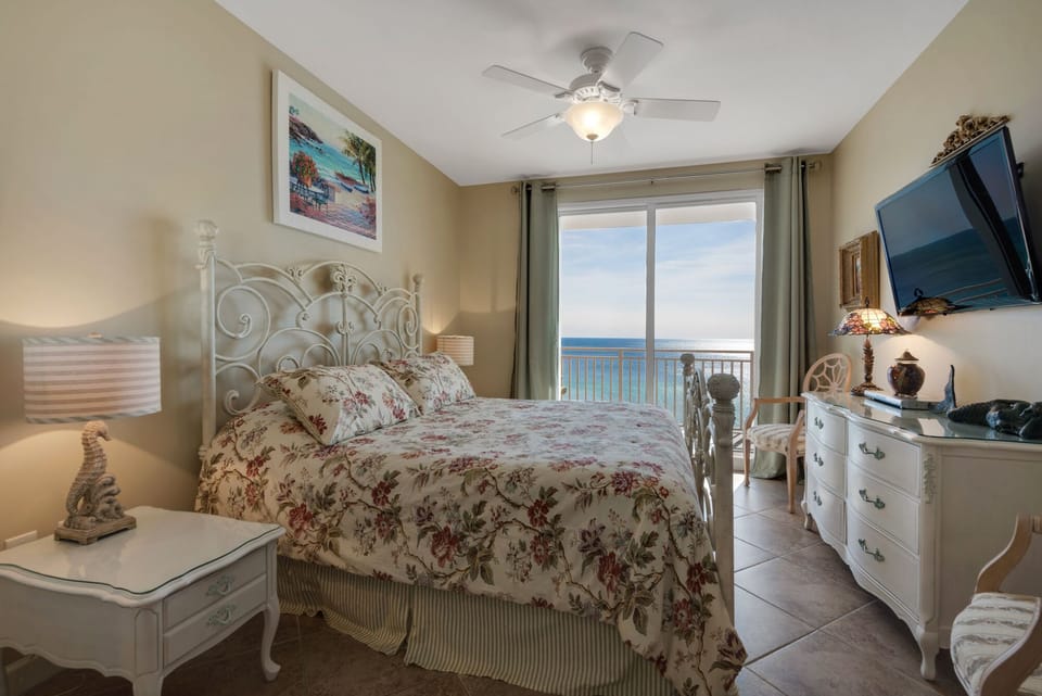 Master bedroom having a Wesley Allen wrought iron king bed & custom draperies. 