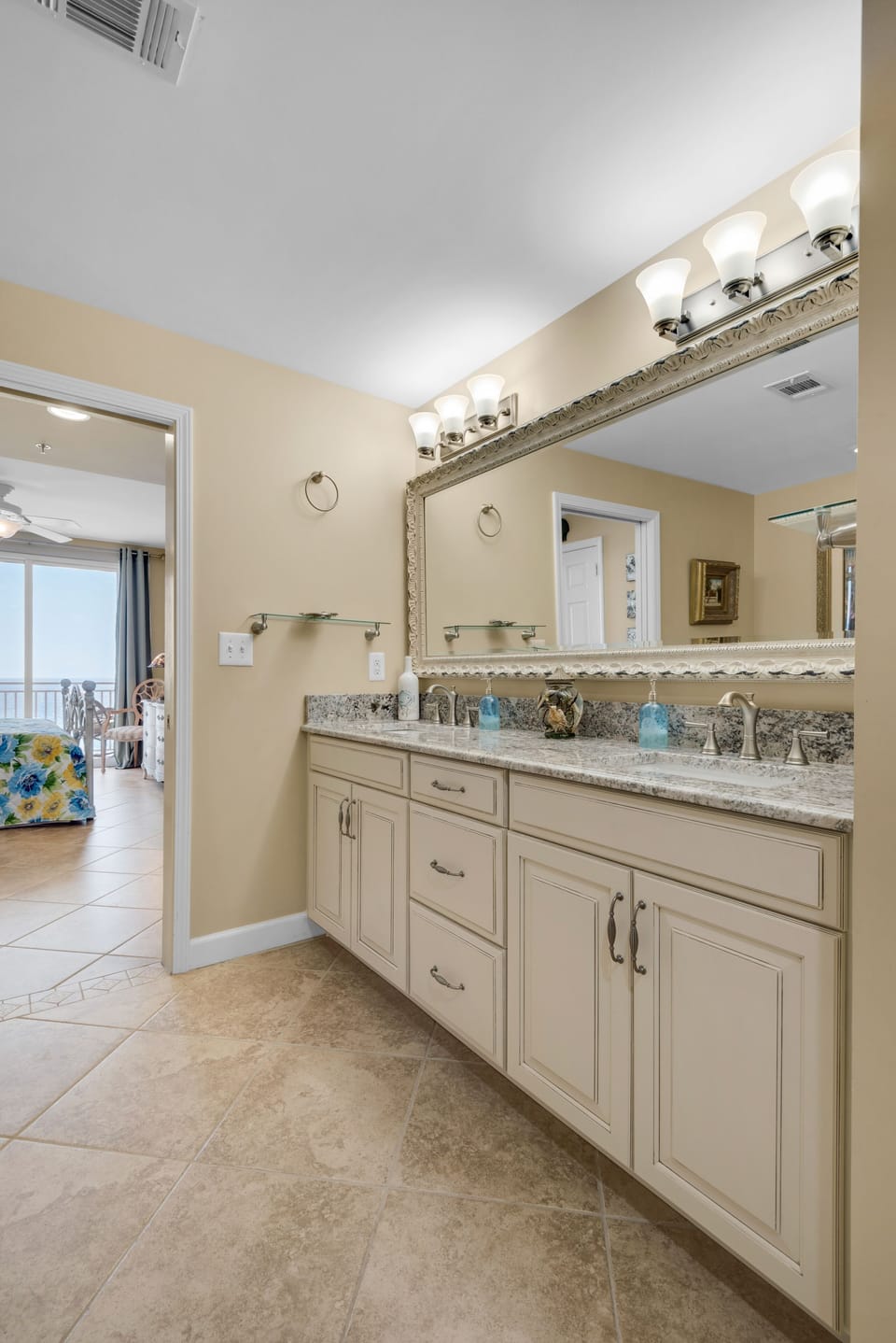 View of fully renovated master bathroom towards master bedroom and tile floors.