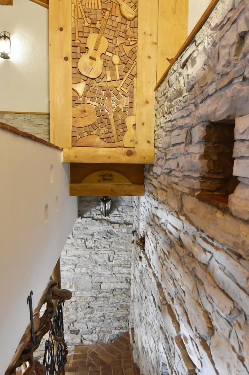 The decoration of the hand-carved wooden wall above the staircase
