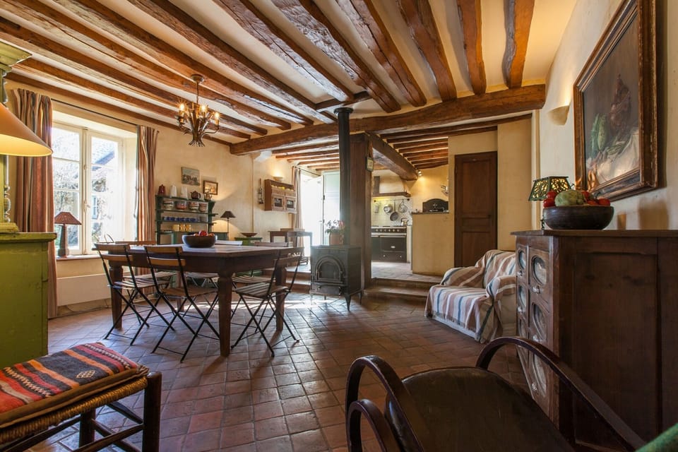 The dining room with the kitchen in the background