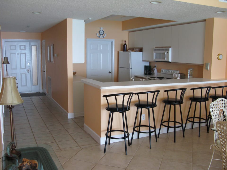 Main entry, kitchen with large door leading to laundry room with washer/dryer