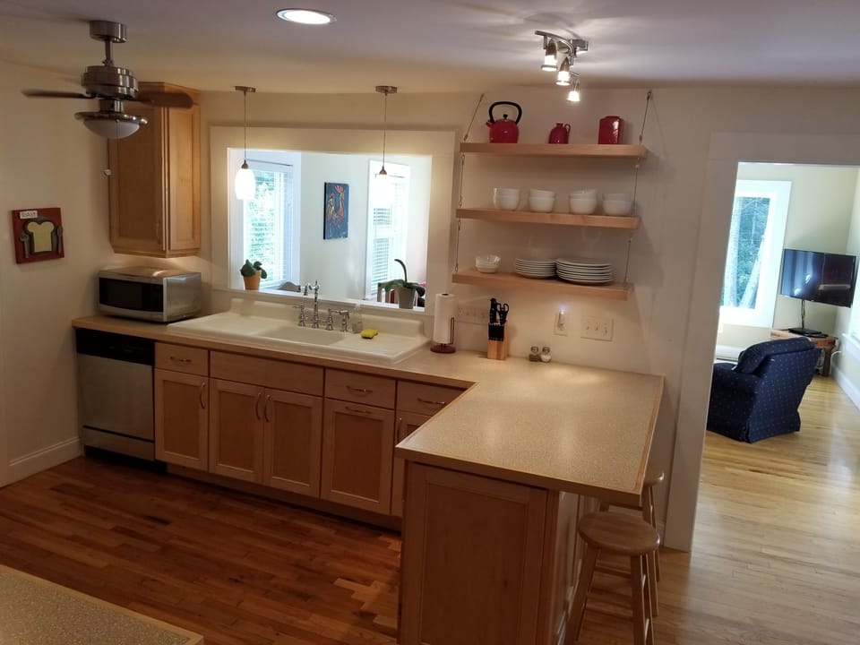 Modern farmhouse kitchen with a view into the great room and backyard