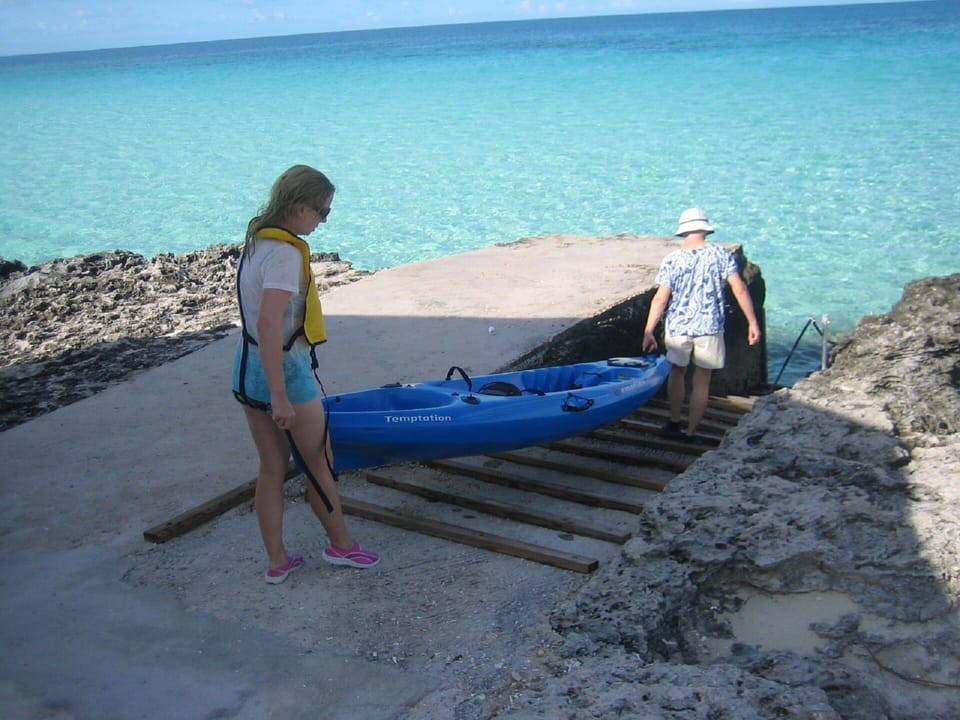 Launching kayak from walkway to the sea
