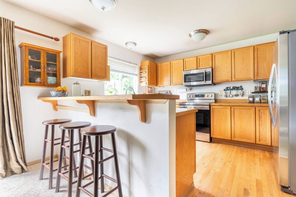 The kitchen has bar stools.