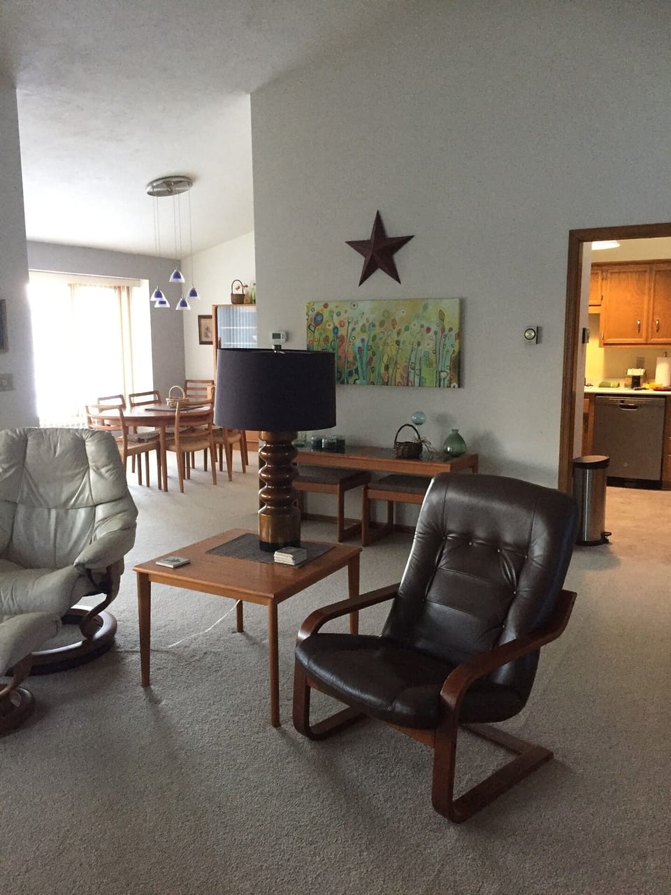 VAULTED LIVING ROOM LOOKING INTO KITCHEN AND DINING AREA