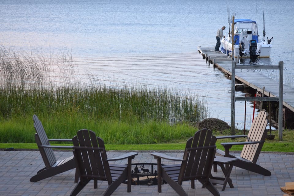 Lakeside patio with fire ring and chairs