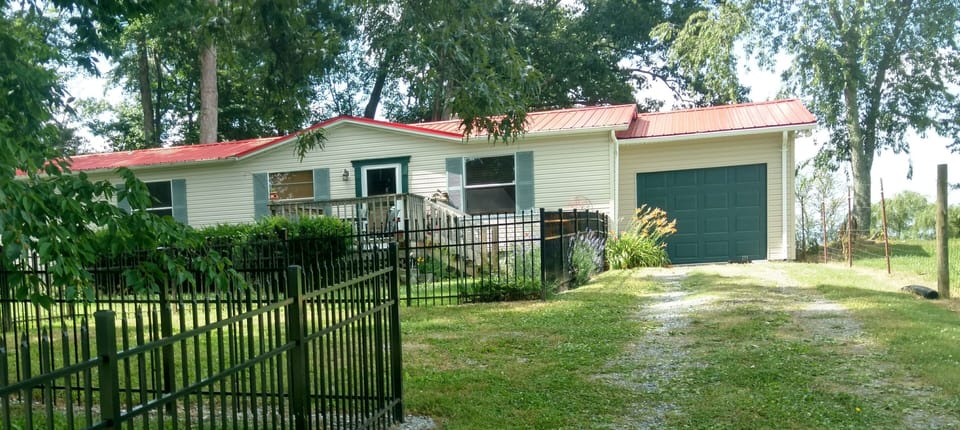 FRONT OF HOUSE WITH FENCED IN FRONT YARD